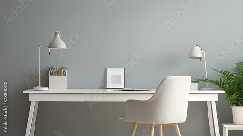 Minimalist white desk with a gray chair and green plant, perfect for a modern home office. 
