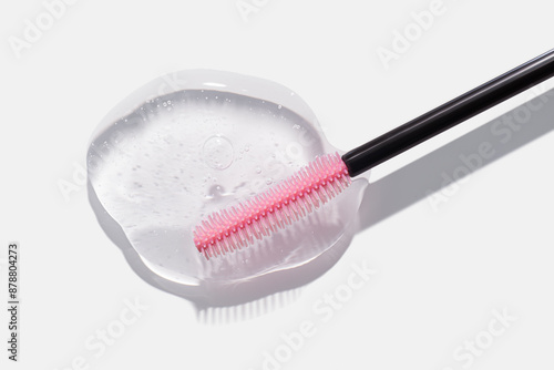 Obraz na plátně Cosmetic eyelashes and eyebrows care or styling oil gel texture swatch with pink