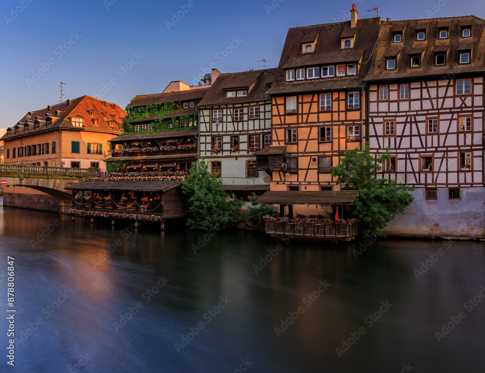 Half timbered houses by canals of Petite France in Strasbourg, France at sunset Half timbered houses by canals of Petite France in Strasbourg, France at sunset