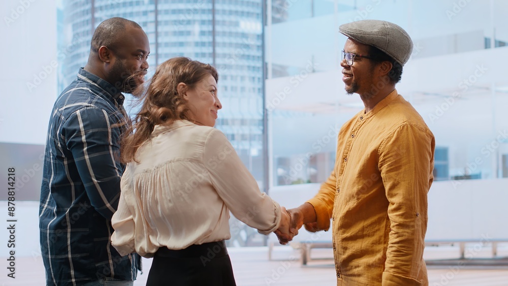 Fototapeta premium Skilled realtor salesman greeting business people for an office tour, examining new corporation workspace in an urban high class building. Development with real estate investment strategy. Camera B.