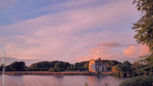 4k time lapse, dramatic cloudy sunset at Menlo castle by Corrib river at Galway, Ireland, medieval architercture, historical landmark photo