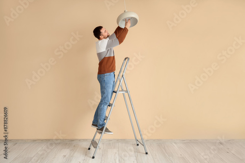 Young man on stepladder cha...