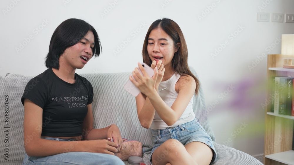 Girl and LGBTQ friend enjoy choosing bold lipstick shades and experimenting with different makeup looks to express their creativity and favorite styles. Girl and LGBTQ friend enjoy choosing bold lipstick shades and experimenting with different makeup looks to express their creativity and favorite styles.