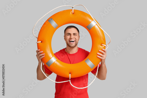 Happy young lifeguard with ...