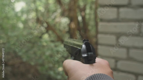 Gun in hand first person view slow motion photo