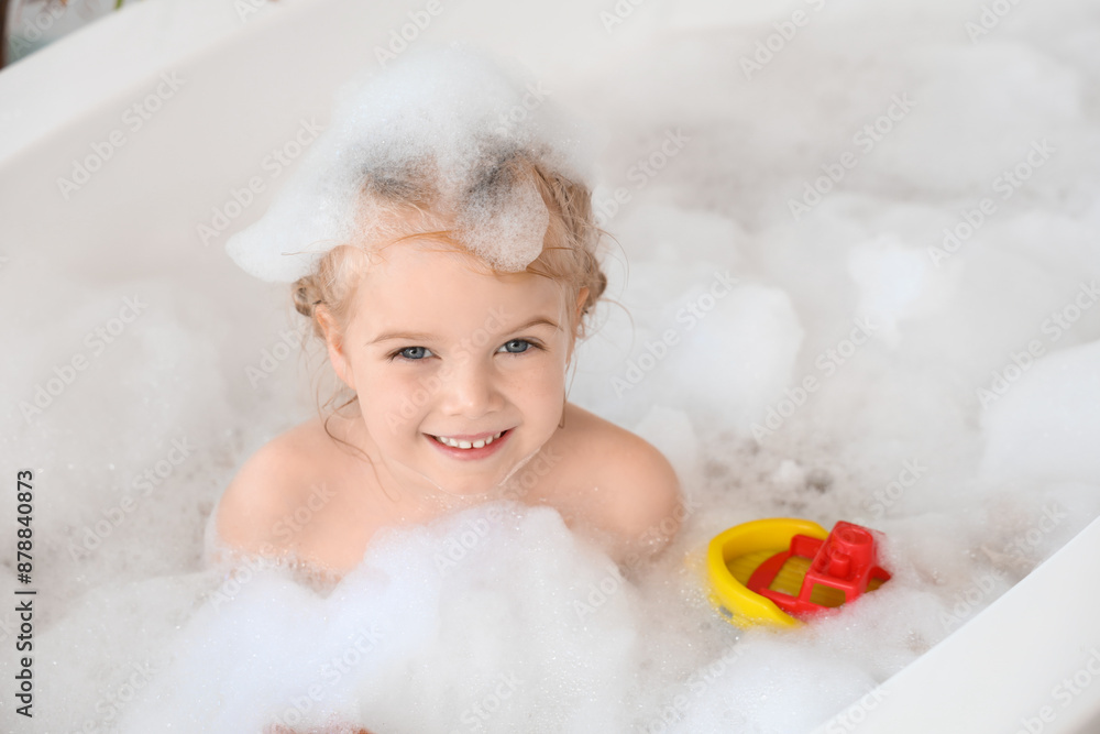 Cute little girl taking bath with foam and toys taking bath in bathroom Cute little girl taking bath with foam and toys taking bath in bathroom