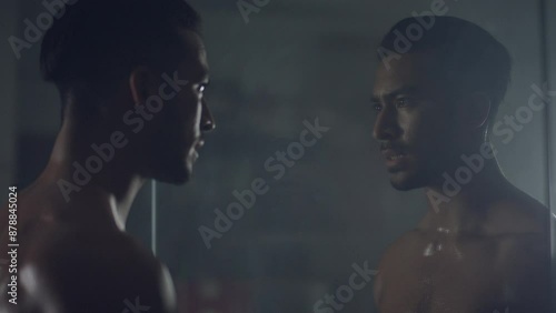 Man looking at himself in the mirror and screaming