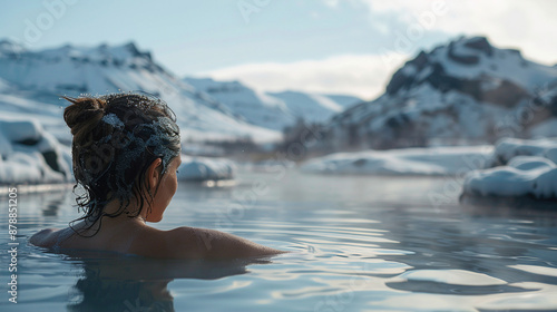 back view of a girl bathes in a blue lagoon in iceland, cinematic, in the open air with a gorgeous view of the snowy mountains. Incredible iceland in winter