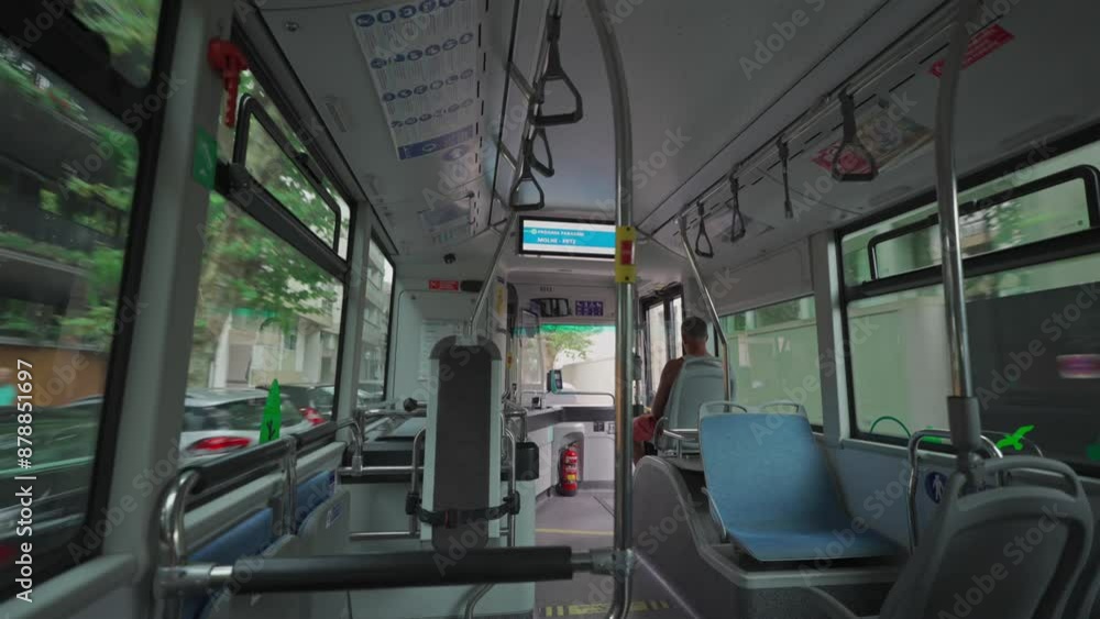 Interior inside city bus during trip to Porto, Portugal in summer. Theme urban public transportation in Opoto, Portuguese. View from passenger seats to interior of fast moving bus. Coach saloon. Interior inside city bus during trip to Porto, Portugal in summer. Theme urban public transportation in Opoto, Portuguese. View from passenger seats to interior of fast moving bus. Coach saloon.