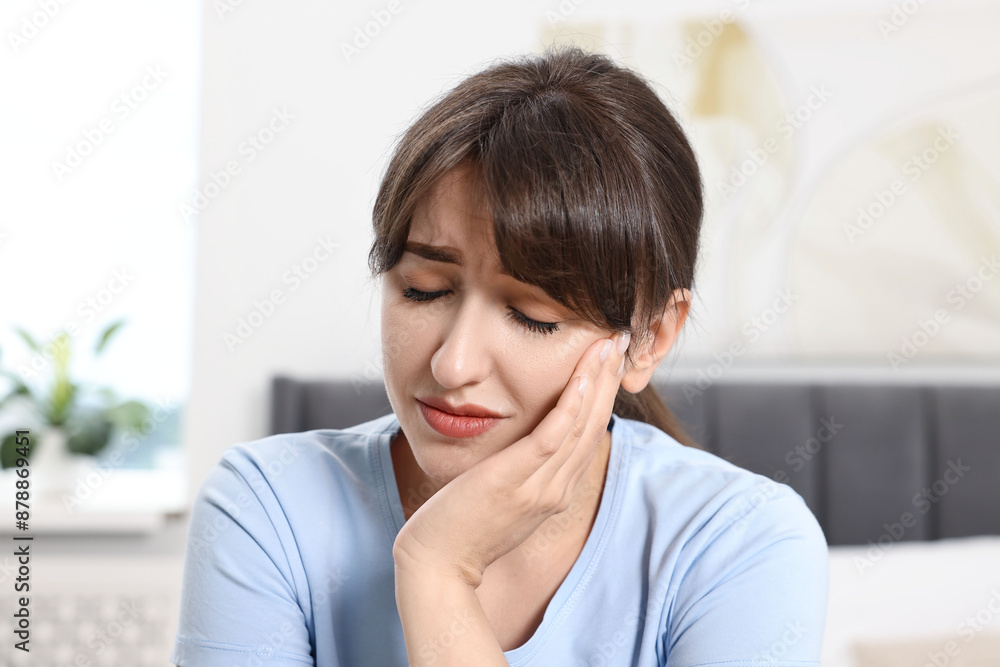 Upset young woman suffering from toothache indoors Upset young woman suffering from toothache indoors