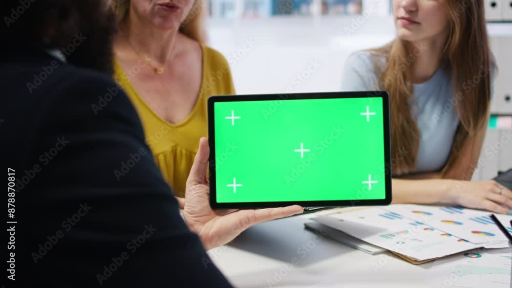 Clients looking over personalized planning guide on isolated screen tablet made by financial advisor. Accountant optimizing living expenses for customers using chroma key device, camera A Clients looking over personalized planning guide on isolated screen tablet made by financial advisor. Accountant optimizing living expenses for customers using chroma key device, camera A