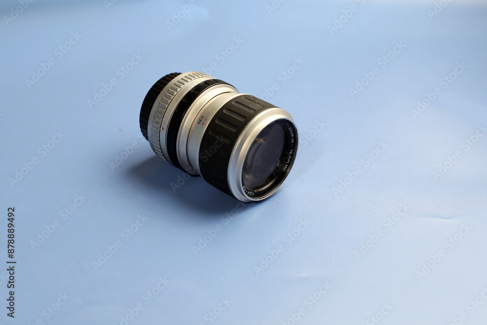 Silver and black colored lenses, made in Germany, on a blue background, SLR lenses Silver and black colored lenses, made in Germany, on a blue background, SLR lenses