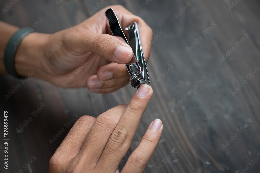 close up of ring finger nail clipping. nail cutting concept. unhealthy lifestyle long and dirty nails. The concept of maintaining body hygiene. Soft focus, selective focus
