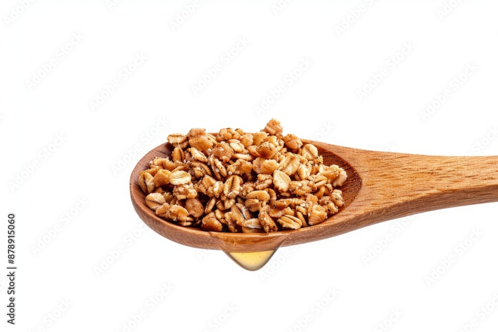 A wooden spoon filled with nuts on a white background A wooden spoon filled with nuts on a white background