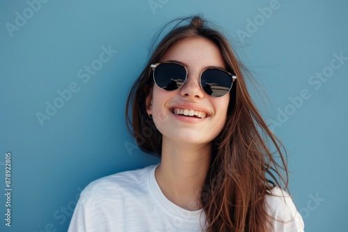 Wallpaper Mural Cheerful young woman in sunglasses against blue background Torontodigital.ca