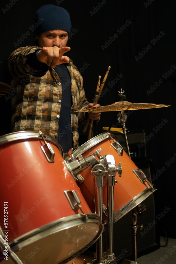 male drummer makes a gesture to the camera male drummer makes a gesture to the camera