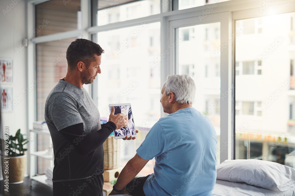 Obraz premium Elderly, man and tablet in physio with Xray consultation for joint injury, healing and treatment planning. Rehab, senior person and chiropractor with digital technology for patient muscle health
