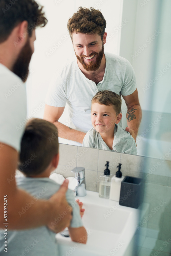 Bathroom, dad and child washing hands with support, smile and teaching healthy hygiene in mirror. Cleaning, happy boy and father getting ready with routine, morning wellness and skincare in home. Bathroom, dad and child washing hands with support, smile and teaching healthy hygiene in mirror. Cleaning, happy boy and father getting ready with routine, morning wellness and skincare in home.