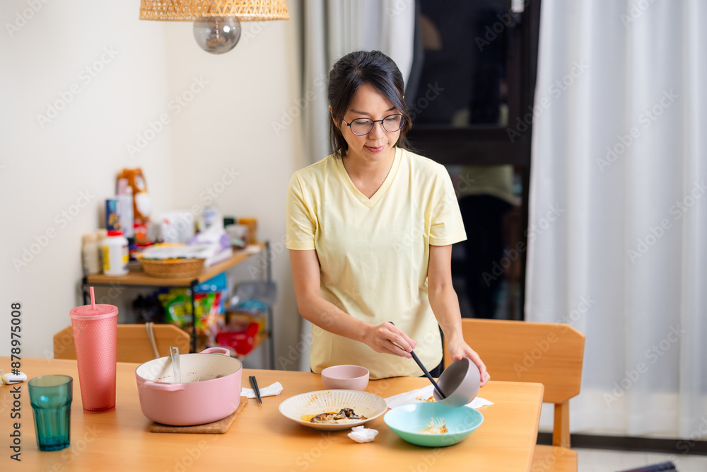 Pregnant woman clean up the table after dinner time at home Pregnant woman clean up the table after dinner time at home