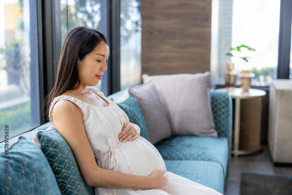Pregnant woman look at her tummy at home Pregnant woman look at her tummy at home