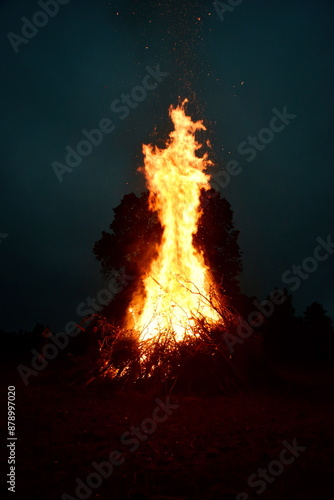 Large Midsummer bonfire at night in Latvia. Burning bonfire with dark background