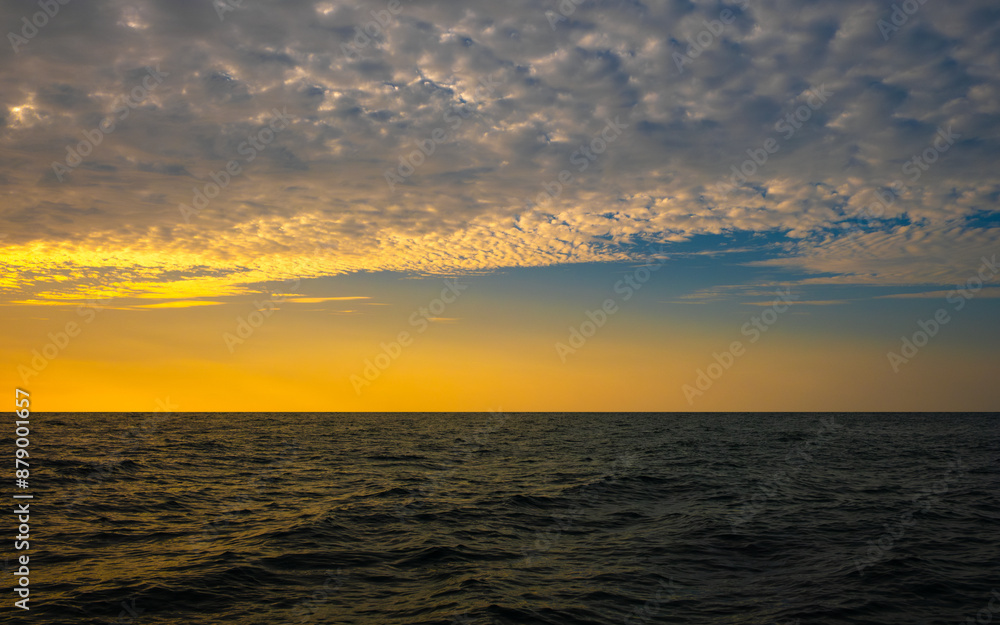 Fototapeta premium Panoramic views of the skyline The sun sets in the evening sky with colorful clouds. and beautiful cloud patterns In the soft light of the evening at sea