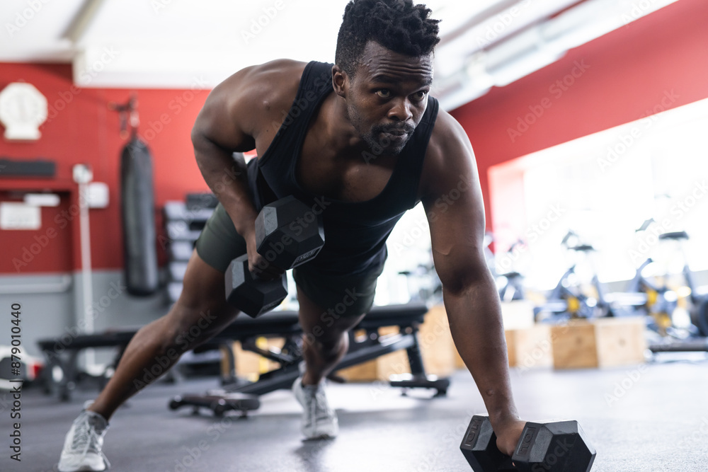 custom made wallpaper toronto digitalFit African American man doing dumbbell rows at the gym