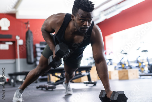 Wallpaper Mural Fit African American man doing dumbbell rows at the gym Torontodigital.ca