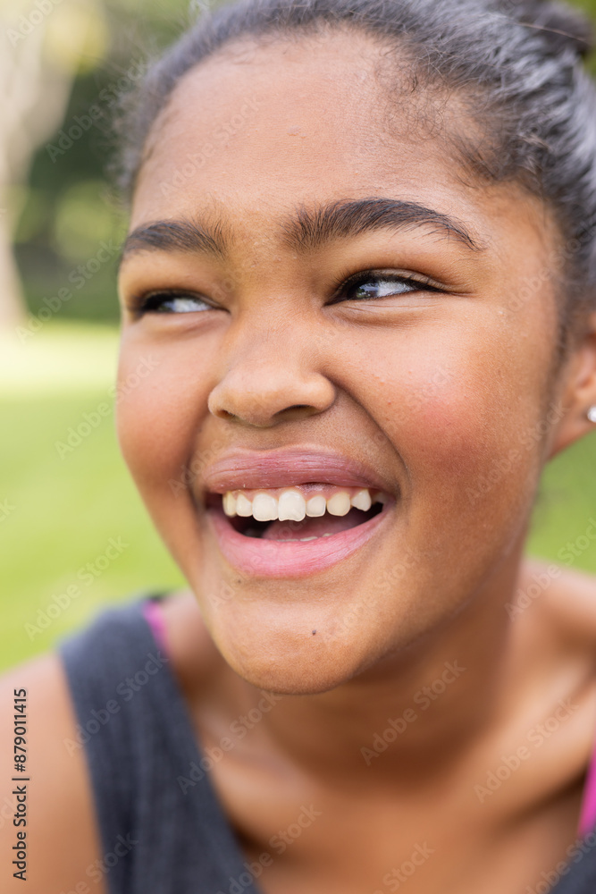 Teenage biracial girl enjoys a sunny day outdoors, with copy space unaltered Teenage biracial girl enjoys a sunny day outdoors, with copy space unaltered
