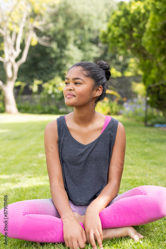 Teenage biracial girl enjoys a sunny day outdoors, with copy space unaltered