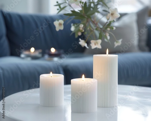 Modern Scandinavian Home Decor - Close-Up of Candles on White Coffee Table, Blue Sofa in Living Room