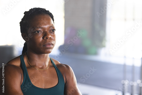 Biracial woman looks thoughtful at the gym photo