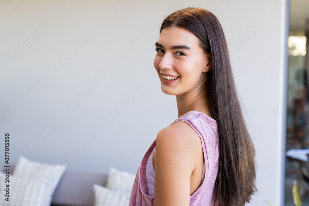 Teenage Caucasian girl smiles at home, looking pretty, with copy space Teenage Caucasian girl smiles at home, looking pretty, with copy space