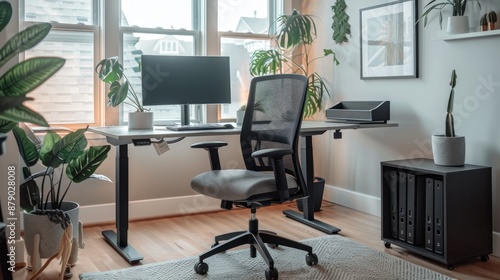 An ergonomic home office chair paired with an adjustable standing desk setup