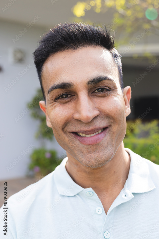 Middle Eastern man smiles warmly outdoors, unaltered Middle Eastern man smiles warmly outdoors, unaltered