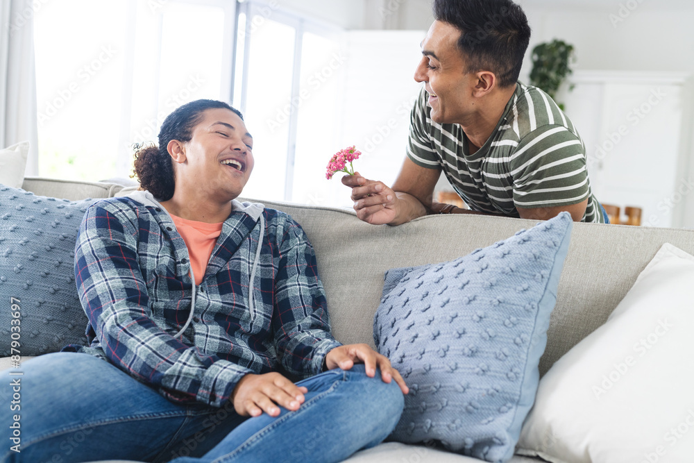 Diverse gay couple enjoys a playful moment at home Diverse gay couple enjoys a playful moment at home