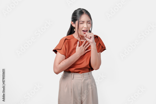 A sick Asian woman in brown shirt coughing and has a runny nose. photo