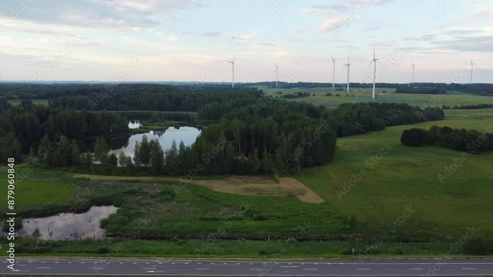 Wind Turbines in Scenic Countryside with Water Body in Aerial view Wind Turbines in Scenic Countryside with Water Body in Aerial view
