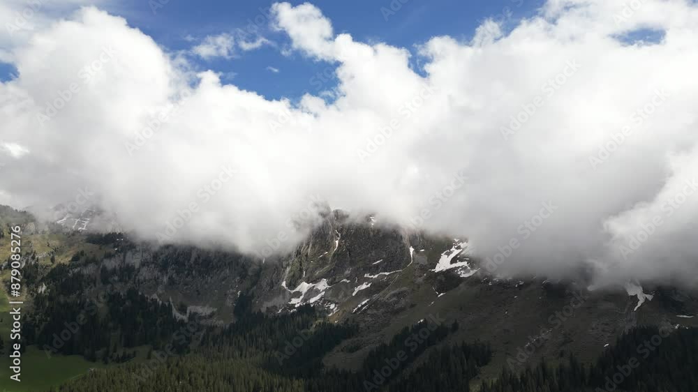 Fronalpstock Glarus Switzerland aerial with fluffy white clouds popping above the mountains Fronalpstock Glarus Switzerland aerial with fluffy white clouds popping above the mountains