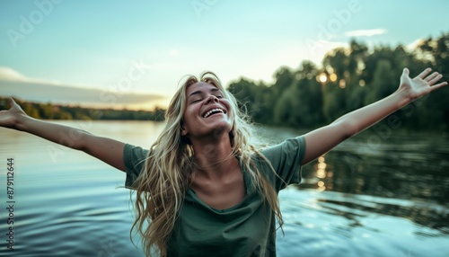 person with arms outstretched outside in the nature.