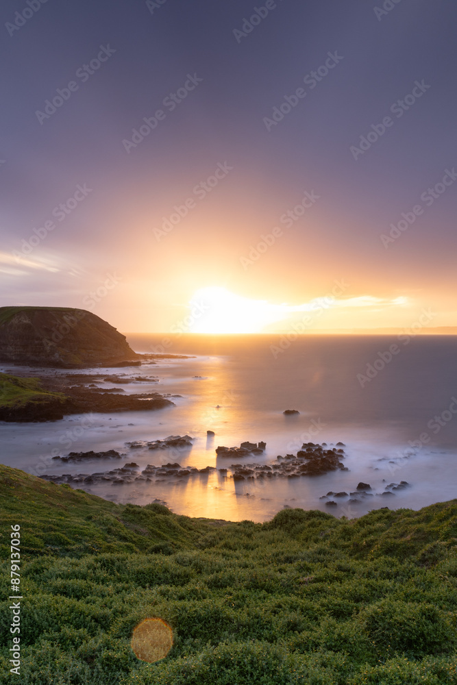 Sunrise over rocky coastal cliff with smooth ocean, Phillip Island Sunrise over rocky coastal cliff with smooth ocean, Phillip Island