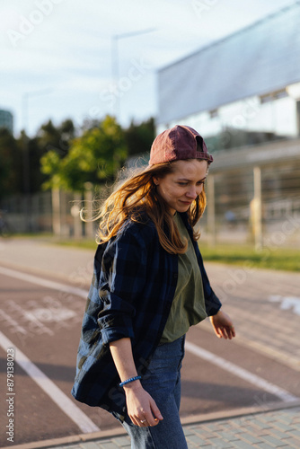 Teenage girl on longboard in the city. photo