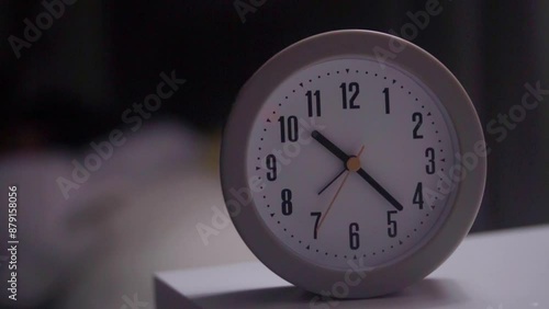 Wallpaper Mural A close-up of a clock on a table with a girl in pajamas lying in bed, unable to sleep and looking at the alarm clock.  Torontodigital.ca