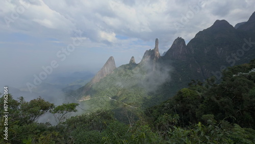 Dramatic Rocky Peaks Surrounded by Lush Jungle and Clouds