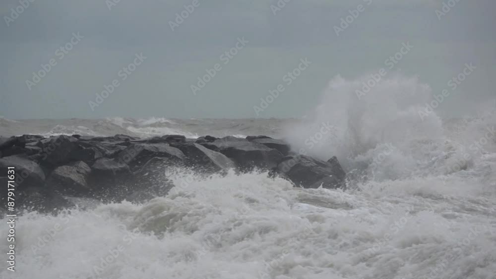 Stormy sea with waves crashing on artificial reefs, winter mediterranean sea. Slow motion Stormy sea with waves crashing on artificial reefs, winter mediterranean sea. Slow motion