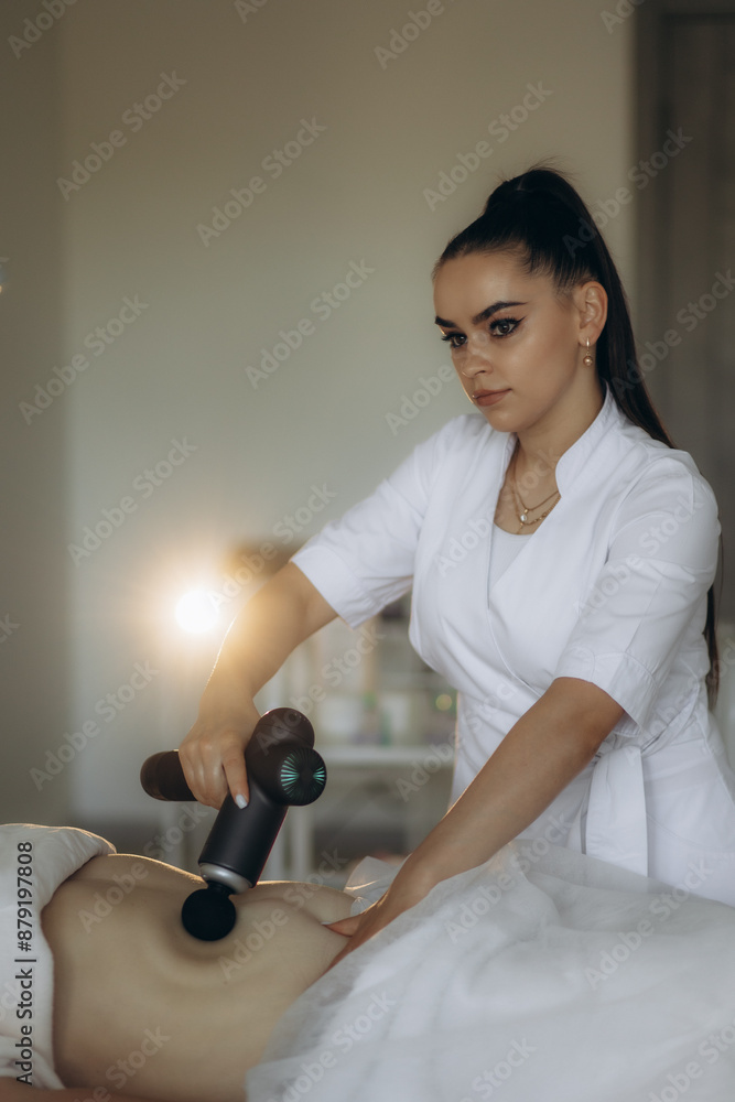 Client undergoes vacuum to facilitate removal of liquefied fat cells. Salon provides aesthetic techniques to achieve slimmer abdominal profile Client undergoes vacuum to facilitate removal of liquefied fat cells. Salon provides aesthetic techniques to achieve slimmer abdominal profile