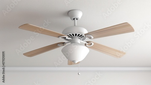 A white ceiling fan with five blades and three lights hangs from a white ceiling. The fan has gold accents around the motor and light fixtures. The lights are covered in white shades photo