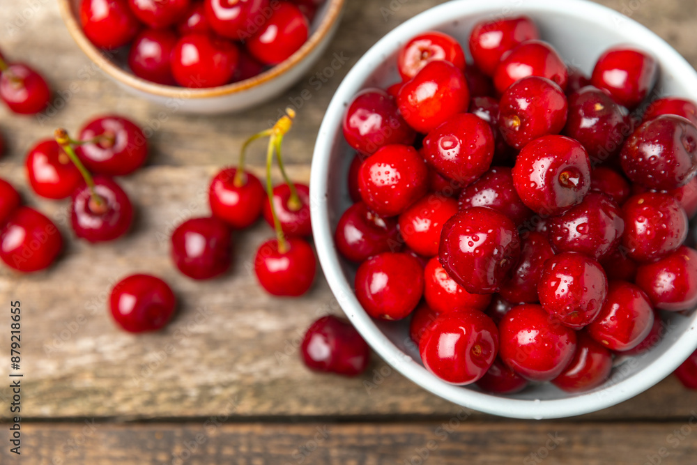 Cherries. Fresh ripe cherries with leaves on a textured wooden background. Fresh sweet organic cherry pile. Berries and fruits. Vegan. Healthy eating. Place for text. Copy space Cherries. Fresh ripe cherries with leaves on a textured wooden background. Fresh sweet organic cherry pile. Berries and fruits. Vegan. Healthy eating. Place for text. Copy space