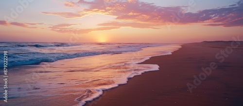 Beach Sunset with Pink Sky and Waves