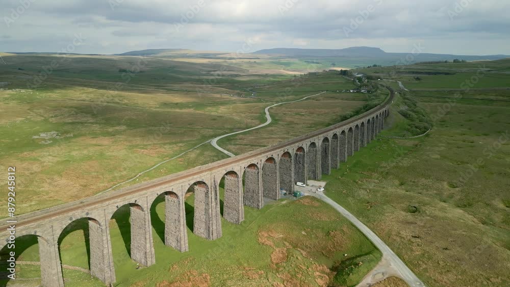 Viaduct railway bridge spanning over Northern English moorland at golden hour. Drone flyover. Ribblehead Viaduct, North Yorkshire, England, UK Viaduct railway bridge spanning over Northern English moorland at golden hour. Drone flyover. Ribblehead Viaduct, North Yorkshire, England, UK